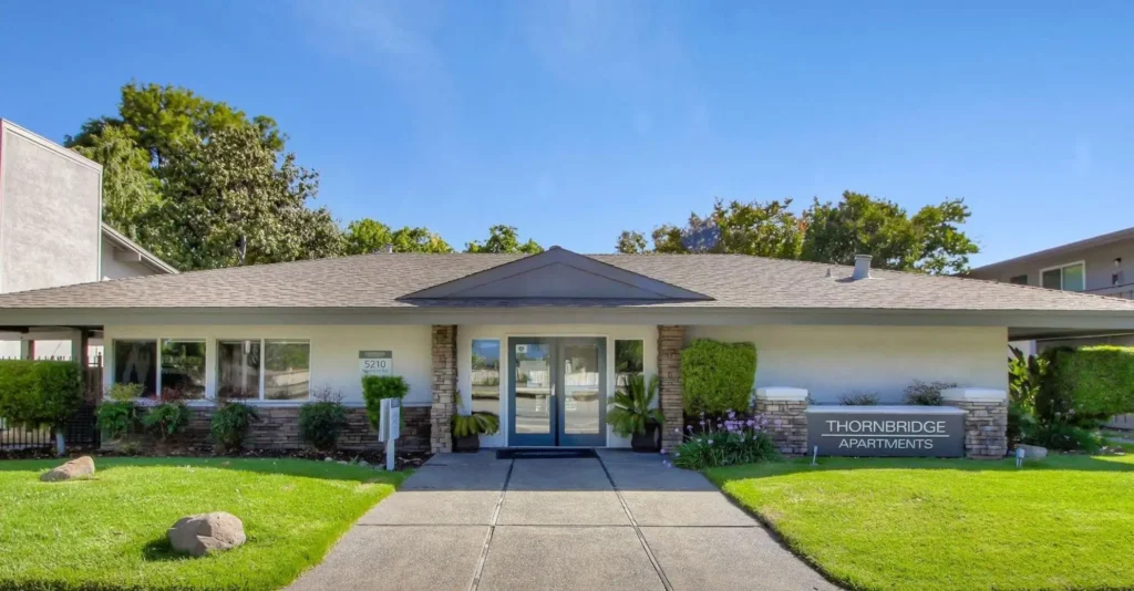 Leasing office exterior with landscaped sidewalk leading up to it
