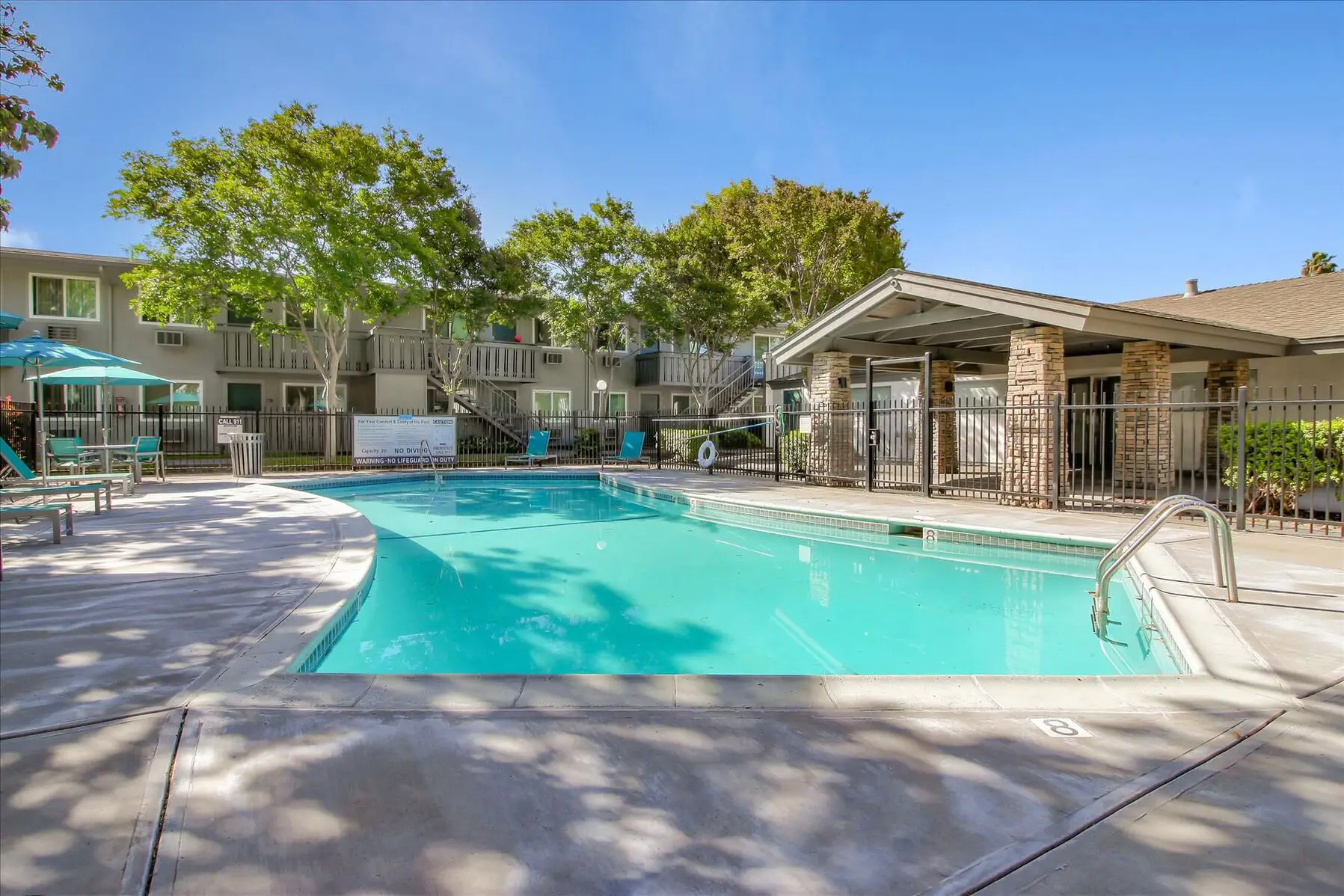 Fenced pool deck with covered and uncovered seating